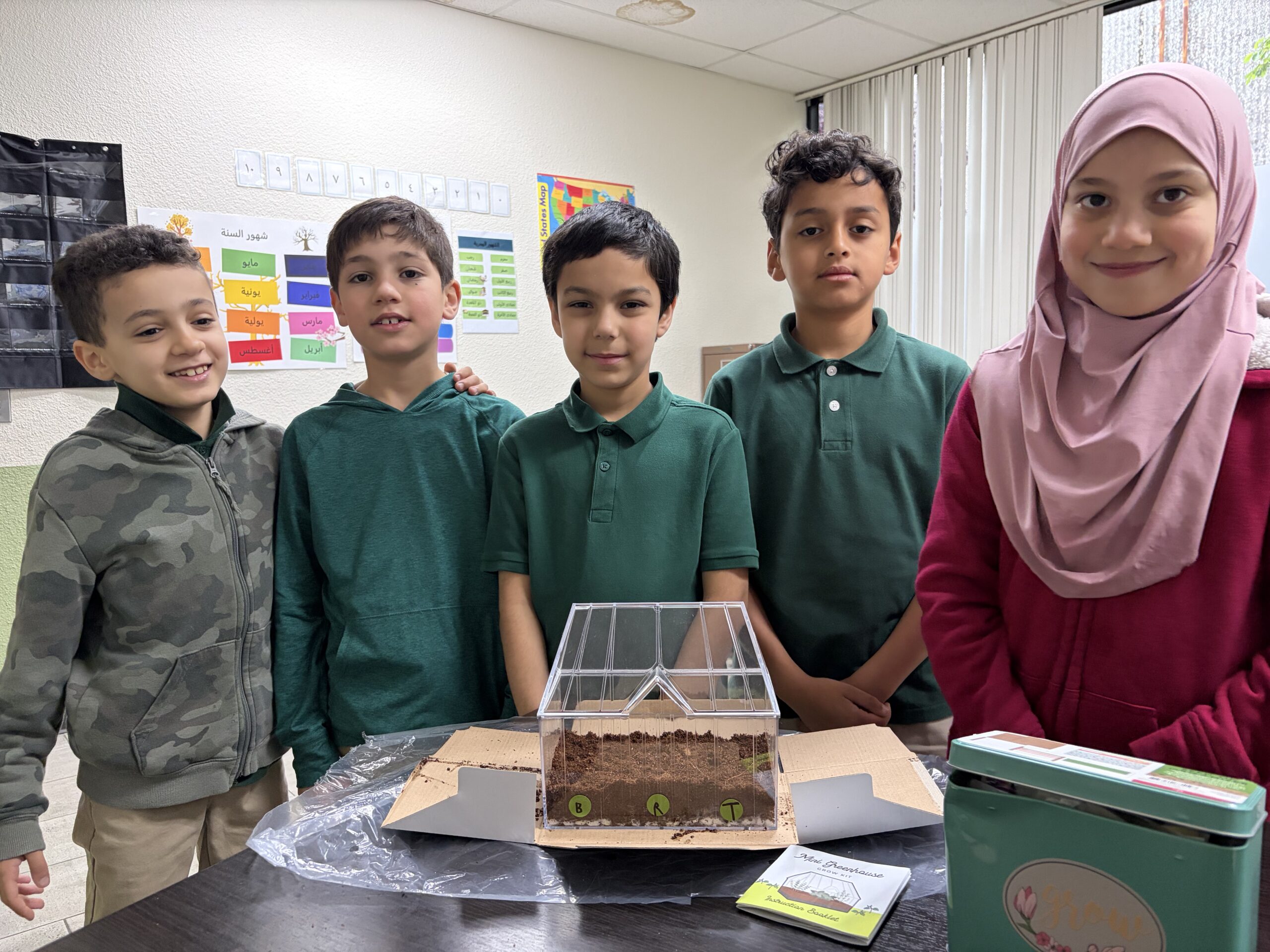 Strive students proudly showing their STEM greenhouse project