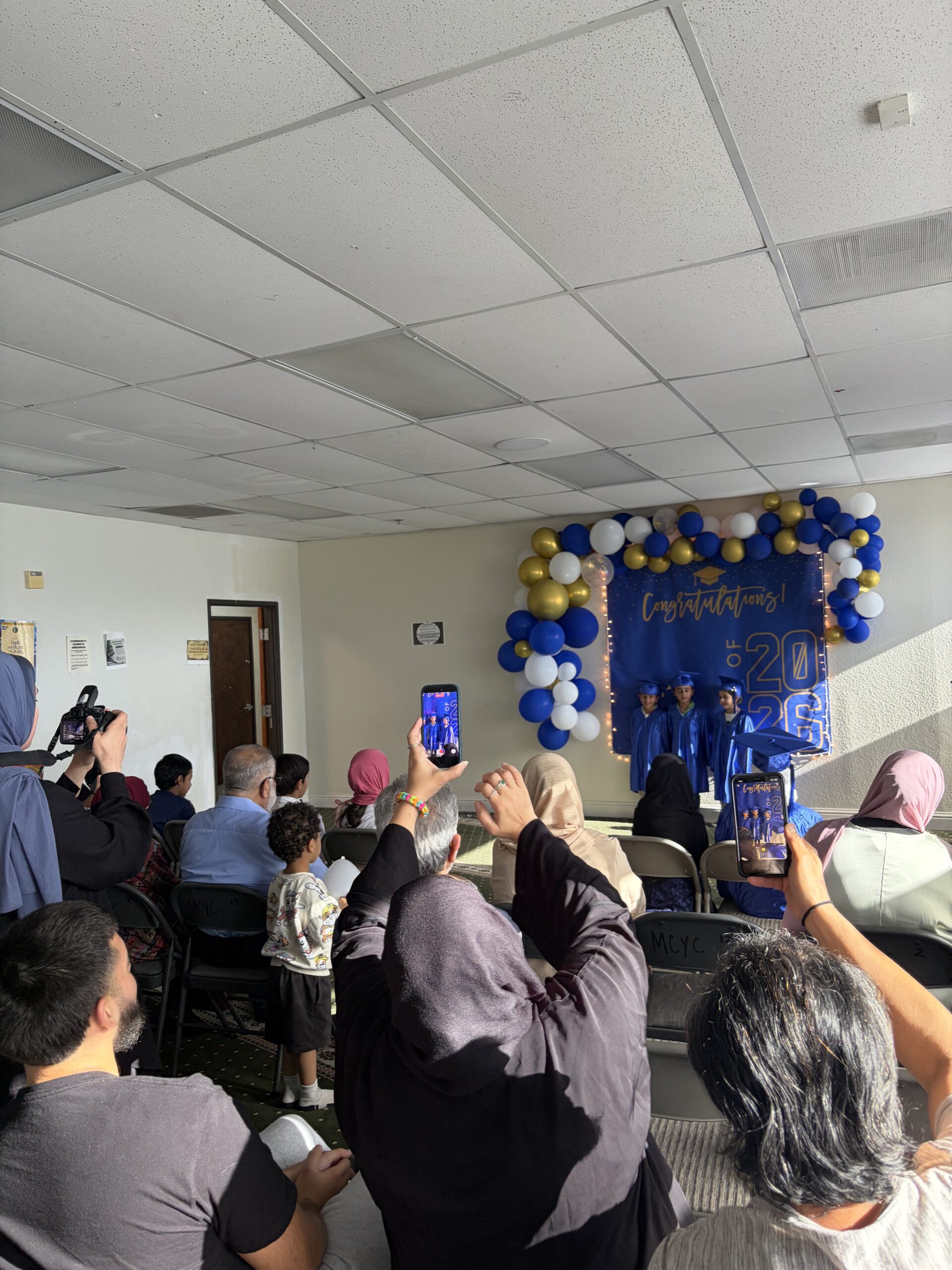 Families cheering at Strive graduation ceremony